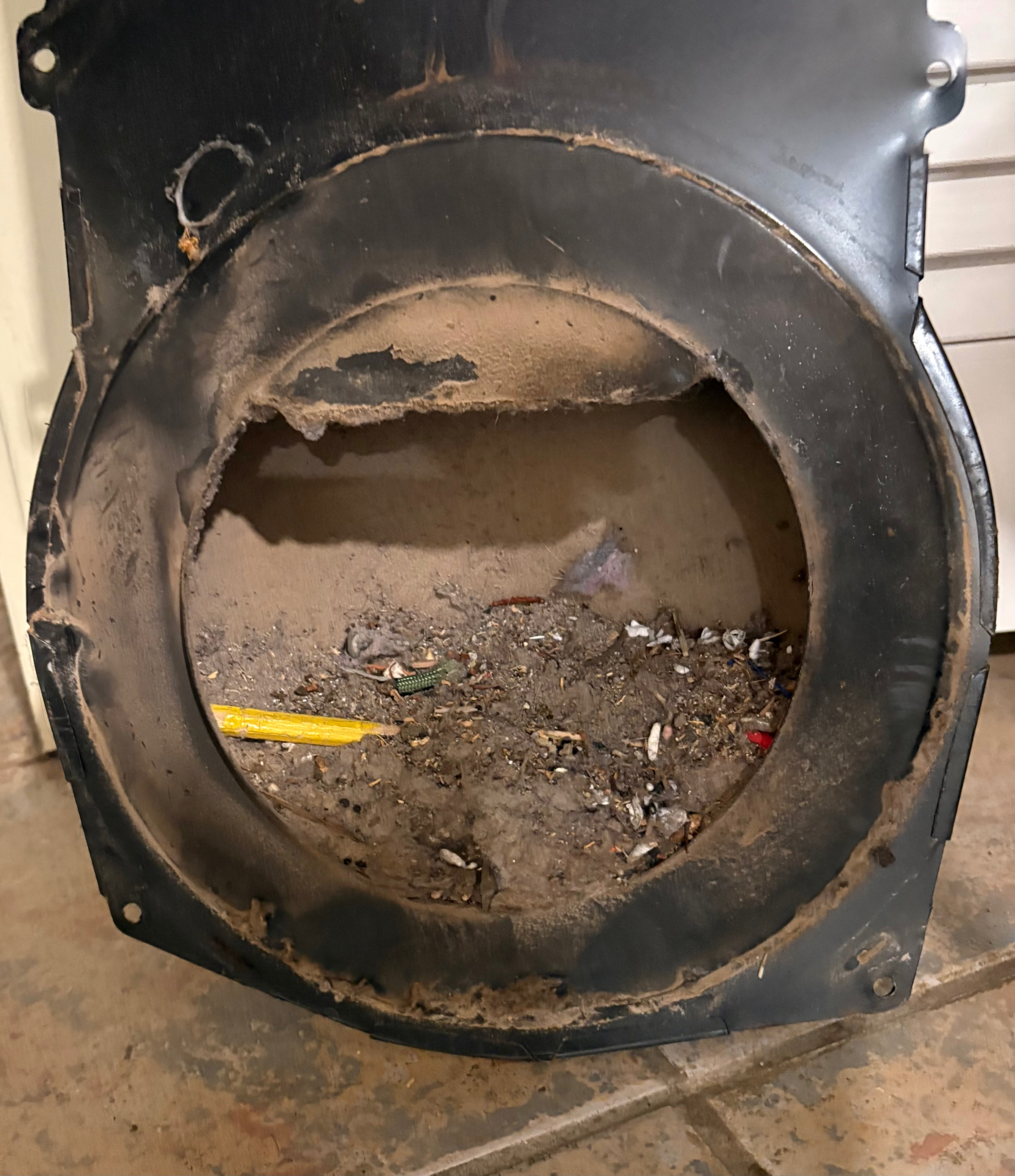 Dryer blower cover removed and shown packed with lint and debris during a Knapp's service call in the Portland area.