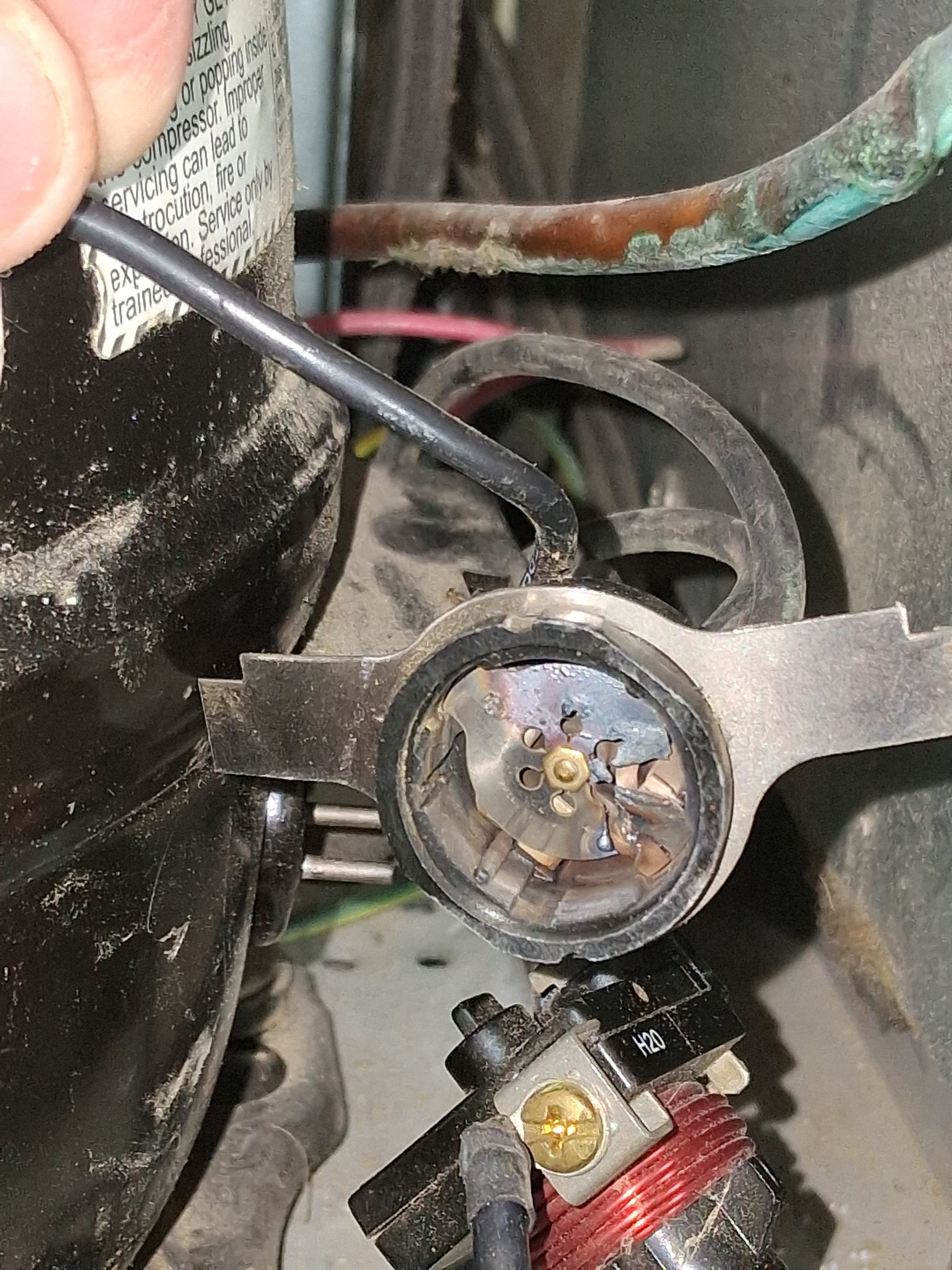Melted refrigerator compressor start relay documented during a Knapp's service call in the Portland area.