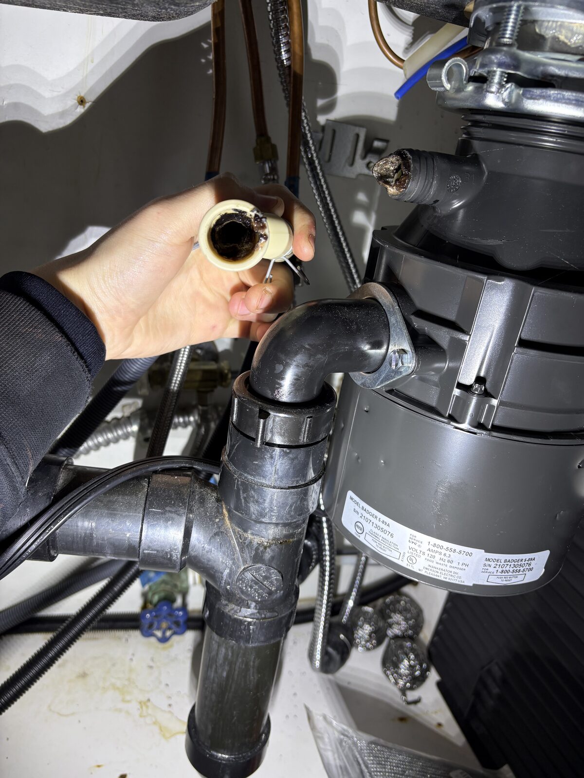 Dishwasher drain line clogged with debris documented during a Knapp's service call in the Portland area.